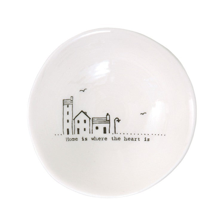 Home is where the heart is written on a white bowl with house illustration