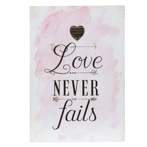 Pink ink splashed poster with Love never fails in black calligraphy